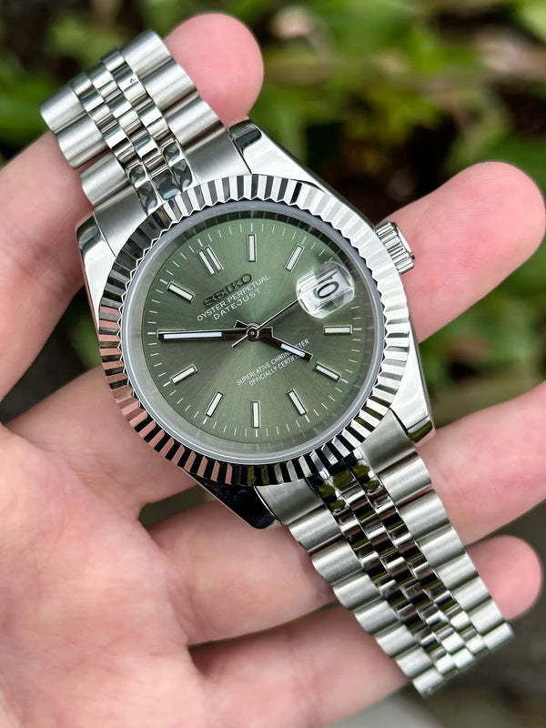 Customer holding a green dial datejust watch mod