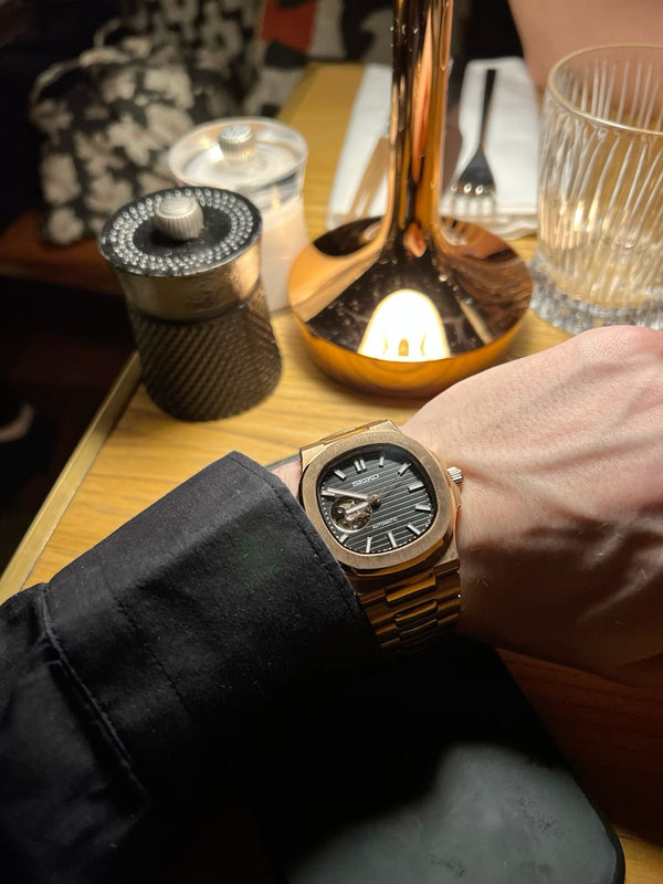 Customer wearing a rose gold watch mod at dinner